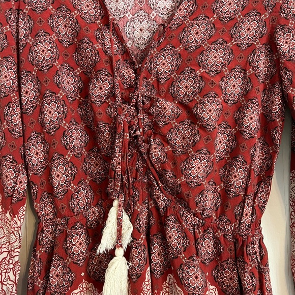 Red printed long sleeve romper. Sinched tie up detail in front with tassels - Picture 2 of 3